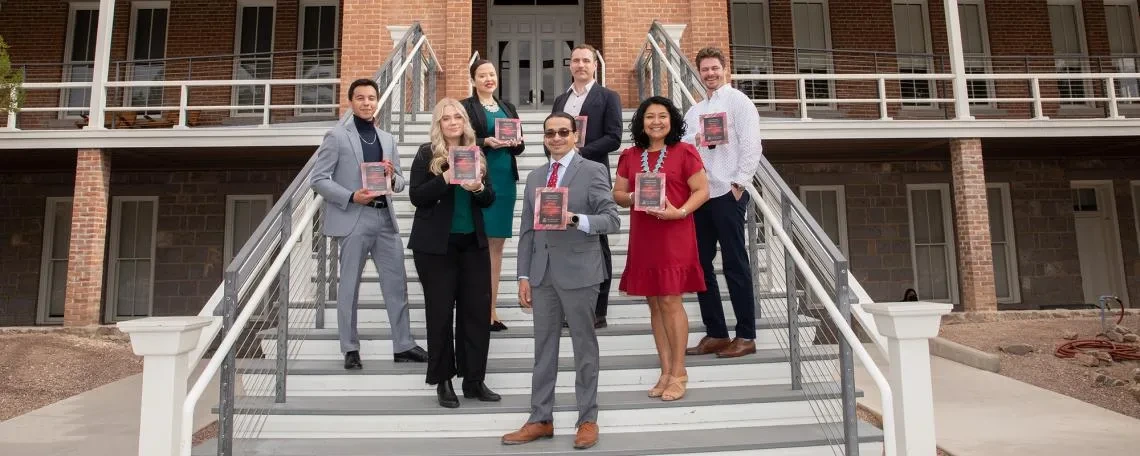 Photo of Past Centennial Achievement Award Recipients standing on the steps of Old Main