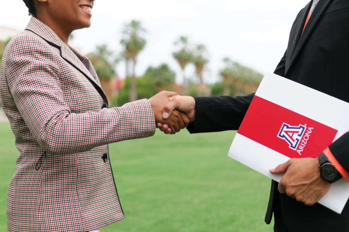 Students preparing for their future careers on campus through networking/shaking hands.